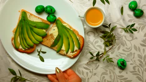 Hand-is-putting-a-white-plate-with-sandwiches