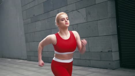 Plus-size-mixed-race-blond-smiling-woman-jogger-wearing-red-sportswear-run-fast