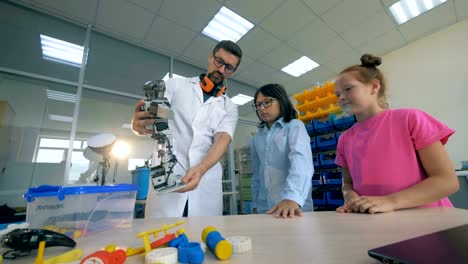 Robotertechnologien-in-der-Grundschule.-Schullehrer-studieren-Robotik-Technik-mit-intelligenten-Schülern