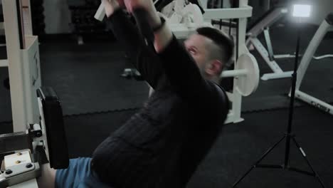 Cheerful-fat-man-performs-a-wrong-exercise-in-the-gym.-For-the-first-time-in-a-fitness-club