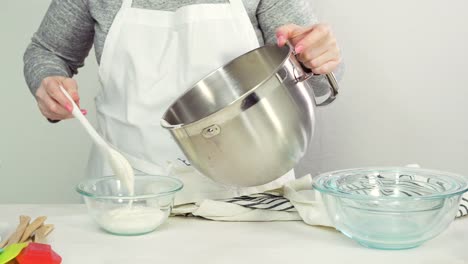 Mixing-royal-icing-to-decorate-Easter-sugar-cookies.