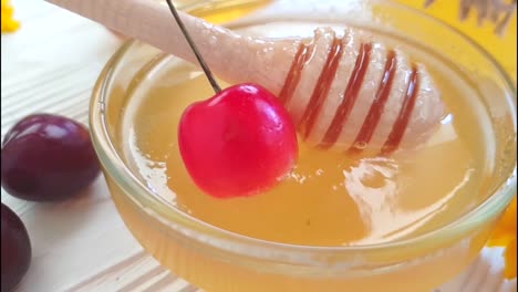 fresh-honey-cherry-on-white-wooden-slow-motion