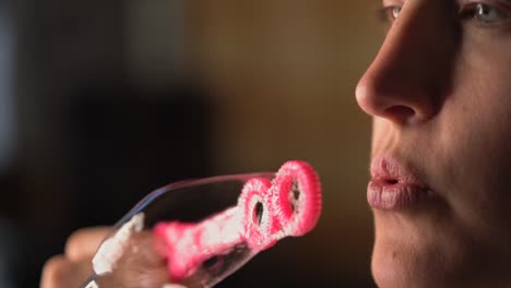 closeup-slow-motion-macro-lips-blowing-bubbles-from-pink-bubble-wand