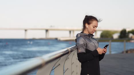 Sportswoman-Using-Telephone-Outdoors