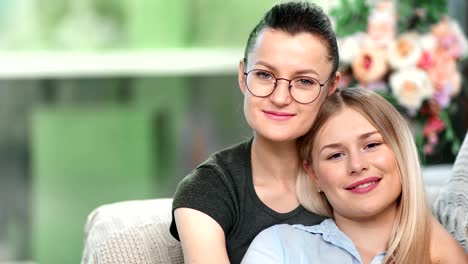 Close-up-face-of-two-happy-lesbian-woman-feeling-love-smiling-hugging-relaxing-together