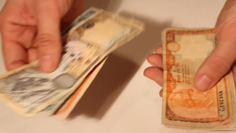 Man's-hands-counting-Nepalese-Rupee-banknotes.-National-Currency-of-Nepal-(NPR)