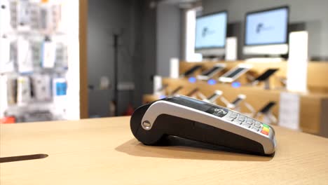 Close-up-of-female-hand-paying-via-plastic-card-with-NFC-chip-on-bank-terminal