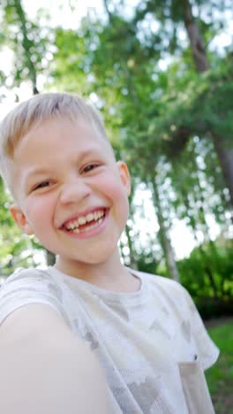 Beautiful-Handsome-Child-Taking-Selfies-on-a-Smartphone-and-Laughing.-One-Boy-on-a-facetime-Videocall-with-Family-Members.-Uncontrollable-Toothy-Laughter.-Video-with-Vertical-Screen-Orientation-9:16