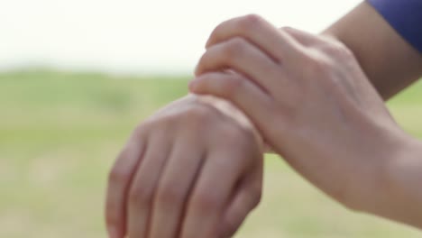 Close-up-athlete-checking-fitness-progress-on-her-smart-watch-after-running-workout.