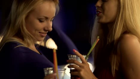 Sexy-blonde-beauties-drinking-cocktails,-dancing-to-music,-flirting-at-party