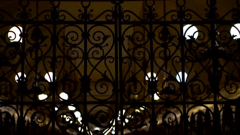 Cloth-Hall-behind-a-locked-iron-gate-night-background