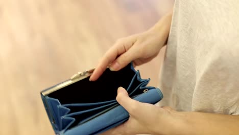 woman-shows-her-empty-wallet.-Bankruptcy.-Bankruptcy---Person-holding-an-empty-wallet.-businesswoman-holding-looking-into-empty-wallet.-The-concept-of-poverty