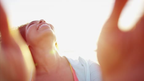 Portrait-of-African-American-female-laughing-by-ocean