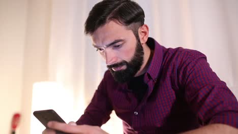 man-using-mobile-phone-at-home.