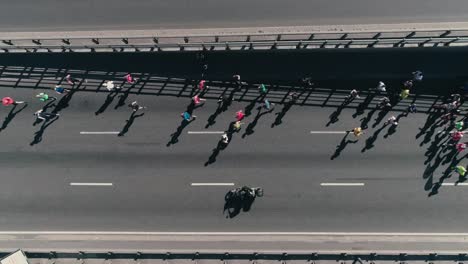 4K-Aerial-drone-fooage.-Marathon-running-on-street.-Group-of-athletes.-Top-view