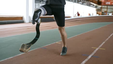 Sportsman-with-Prosthesis-Doing-Jumping-Exercise-on-Track