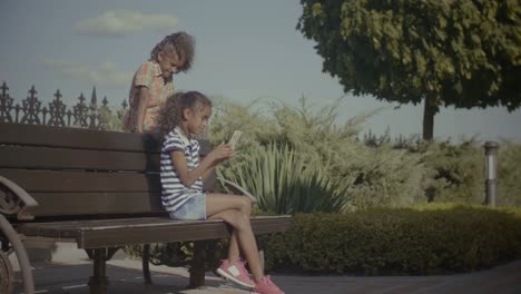 Two-lovely-little-girls-networking-with-cellphone