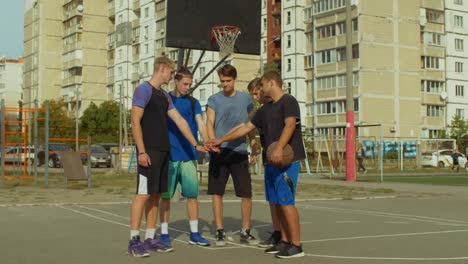 Team-der-Basketball-Spieler-Stapeln-Hände-auf-Platz