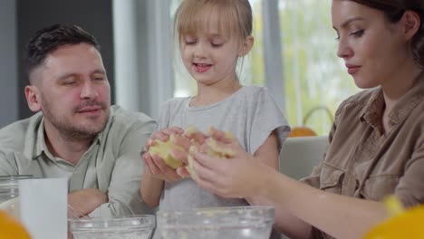 Little-Girl-Kneading-Dough-with-Parents