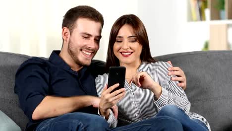 Pareja-navegación-teléfono-inteligente-en-el-hogar