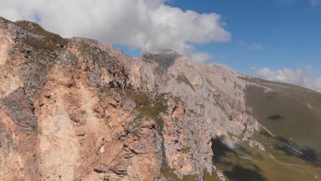 Aerial-photography-group-of-climbers-working-with-a-rope.-Rescue-work-climbing-to-the-top-of-the-mountain.