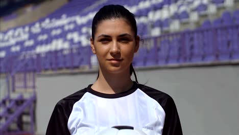 Portrait-of-young-woman-footballer-with-football-soccer-ball-on-stadium,-4k