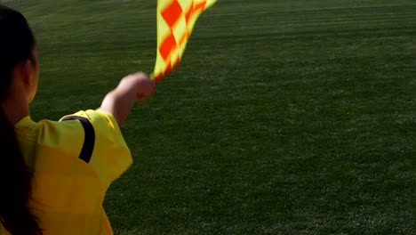 Assistant-female-referee-moving-along-the-sideline-during-a-soccer-match