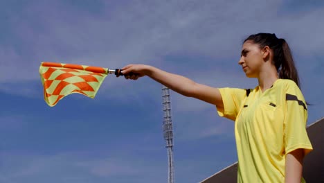 Assistant-female-referee-moving-along-the-sideline-during-a-soccer-match