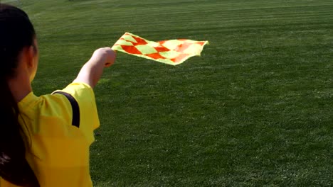 Assistant-female-referee-moving-along-the-sideline-during-a-soccer-match