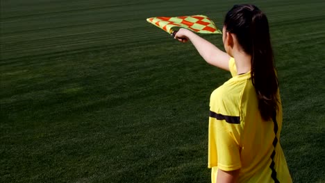 Assistant-female-referee-moving-along-the-sideline-during-a-soccer-match