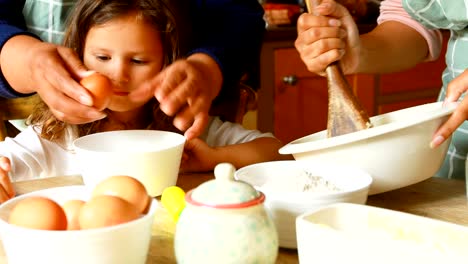 Girl-preparing-food-with-family-in-kitchen-4k