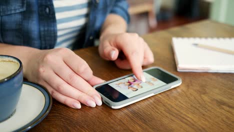 Attractive-Blond-Woman-Swiping-Through-Family-Album-On-Smart-Phone