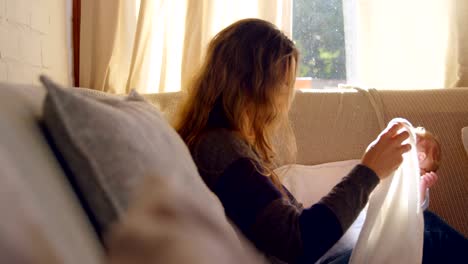 Mother-cleaning-her-baby-face-in-living-room-4k