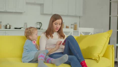 Daugther-being-ignored-by-mom-busy-with-cellphone