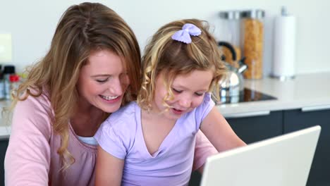 Mother-and-daughter-using-laptop-together