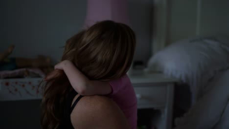 A-little-girl-waking-up-in-the-morning-gets-out-of-bed-and-gives-her-mom-a-big-hug