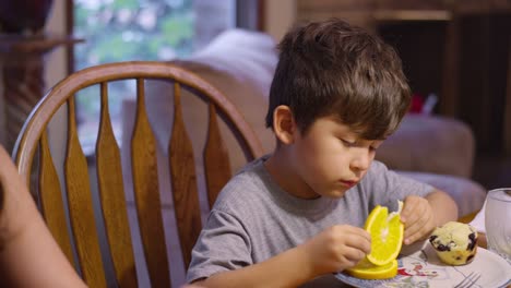 A-boy-eating-dinner-at-the-table-with-his-family