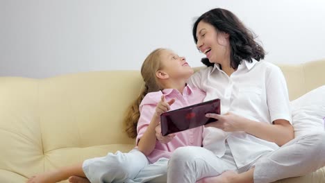 Mother-and-daughter-using-a-tablet-computer.