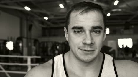 Young-man-in-the-boxing-ring.-Sportsman-looking-at-the-camera-.-Black-and-white-portrait