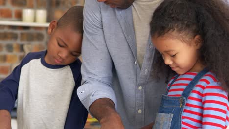 Father-And-Children-Baking-Cakes-In-Kitchen-Together