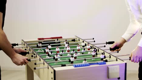 4K-Two-men-playing-table-soccer.