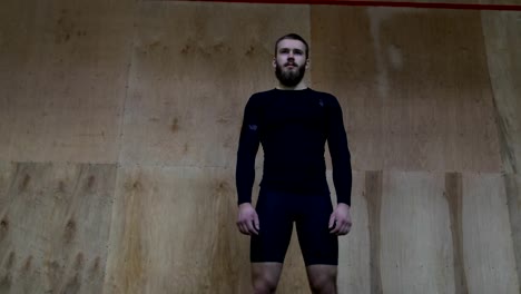 Muscular-Man-Athlete-Portrait-Standing-In-Front-Of-Wall-In-Sport-Club-Before