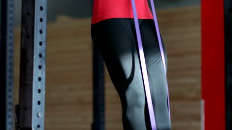 Woman-Hanging-On-Bar-Doing-Pulling-Up-Exercise-During-Workout-Training-At-Gym