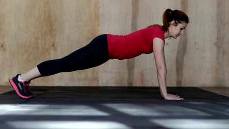 Young-Woman-Doing-Push-Ups-Exercise-During-Workout-Training-At-Gym