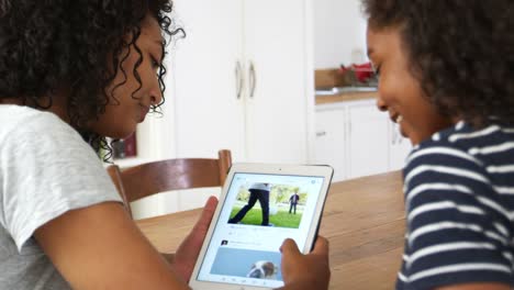 Teenage-Girls-Looking-At-Digital-Tablet-Together