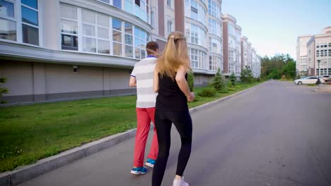 Man-and-woman-meeting-at-the-street,-greeting-each-other-with-fist-bumps