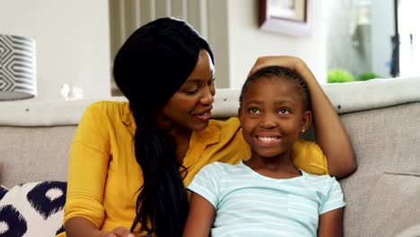 Mother-and-daughter-watching-television-in-living-room-4k