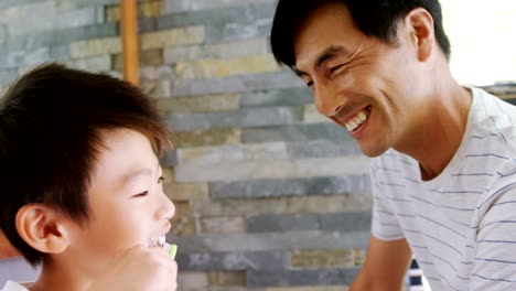 Father-and-son-giving-high-five-to-each-other-in-bathroom-4k