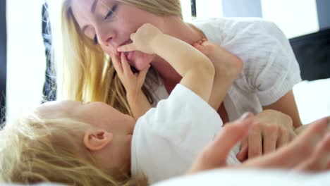 Young-mother-relaxing-and-smiling-with-baby-son