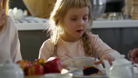 Little-Girl-Enjoying-Sweet-Pie-at-Family-Dinner